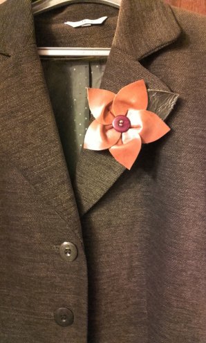Tan leather flower on jacket